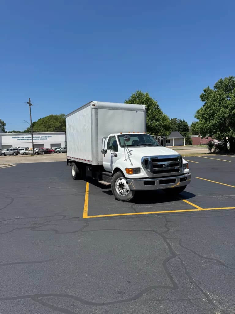 White Ford F-650 box truck in a commercial parking lot