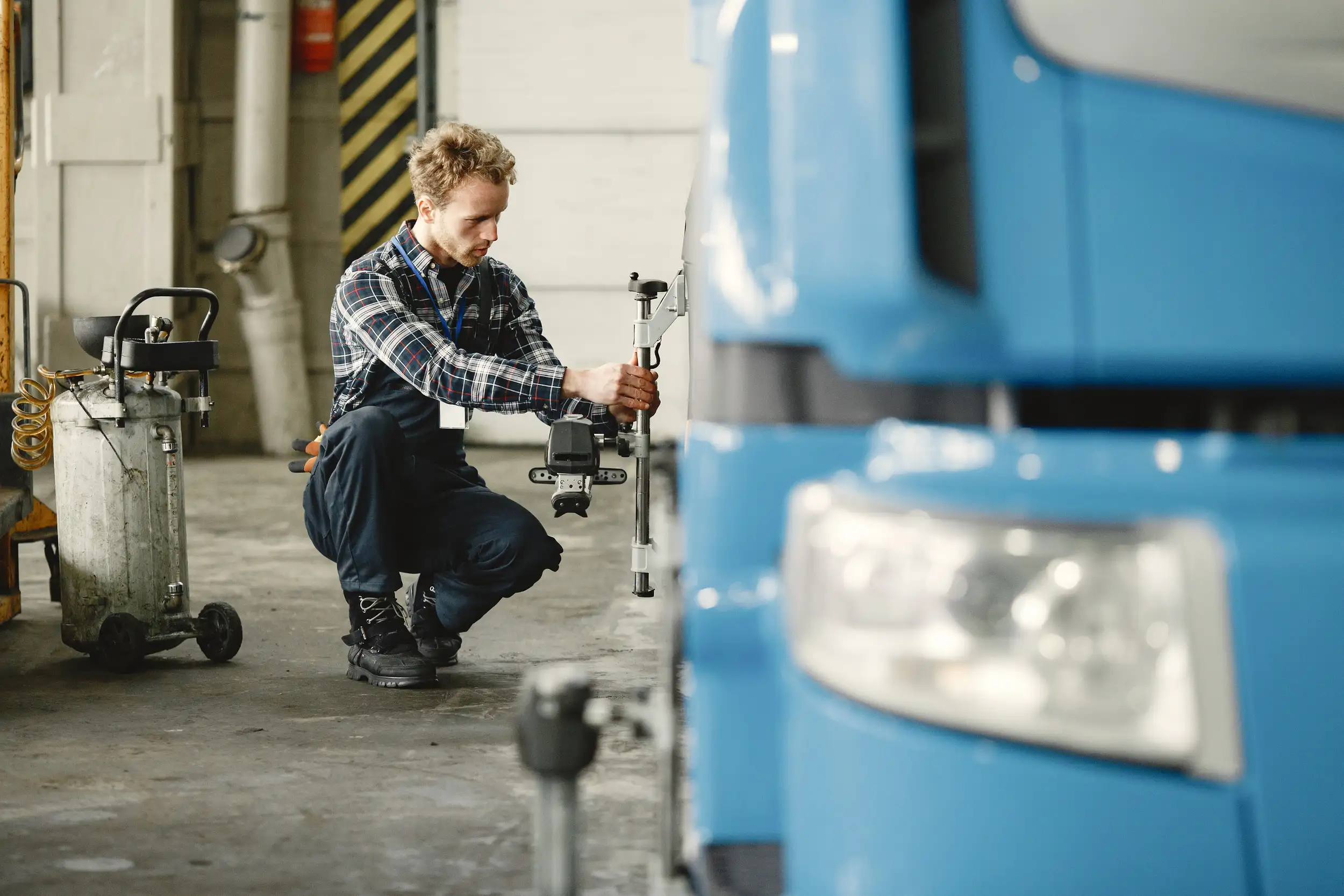 A mechanic measuring and adjusting on the tire part of the truck