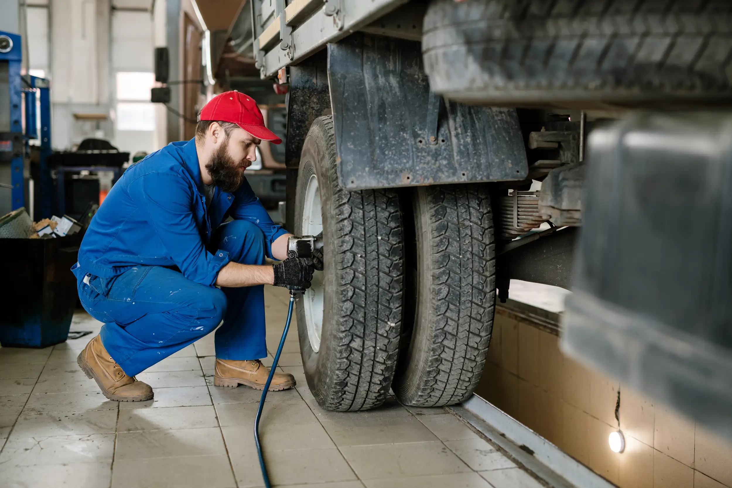 an image of a mechanic adjusting the bolts of the truck