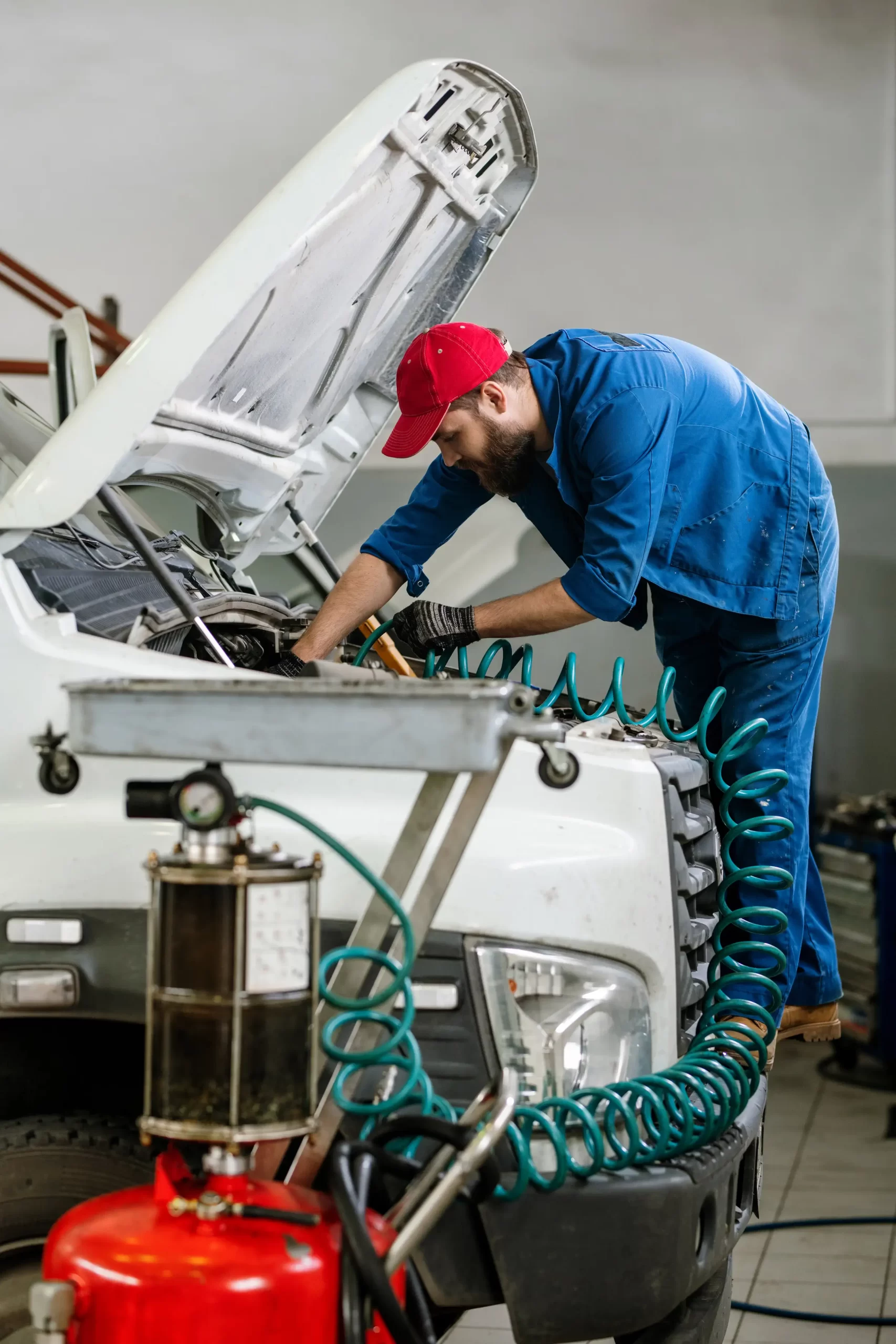 A mechanic using an auto tool device to fix the truck